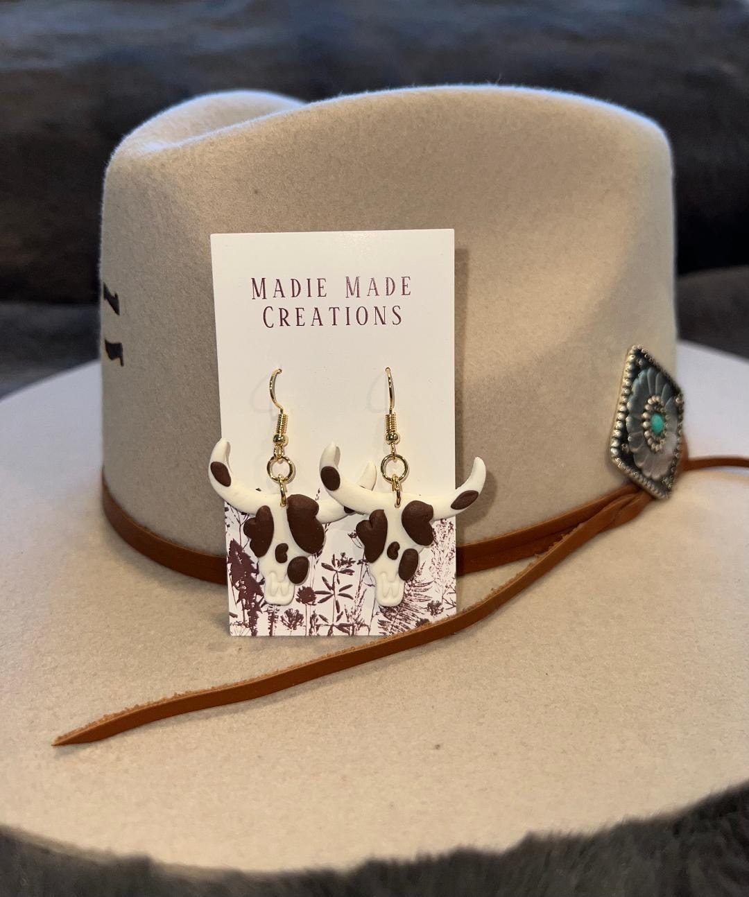 Brown cow print bullhead dangle earrings