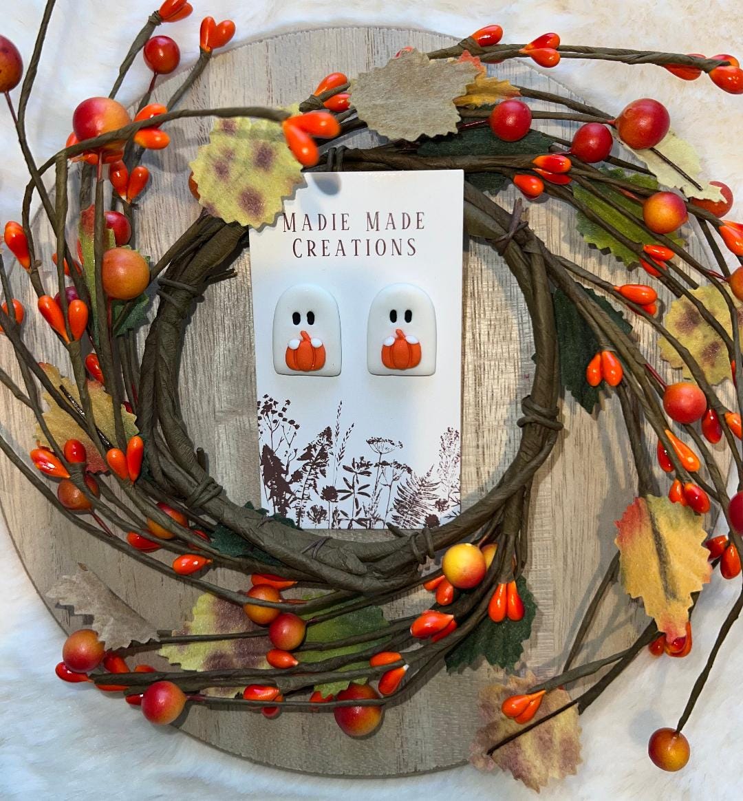 Ghost holding pumpkin studs