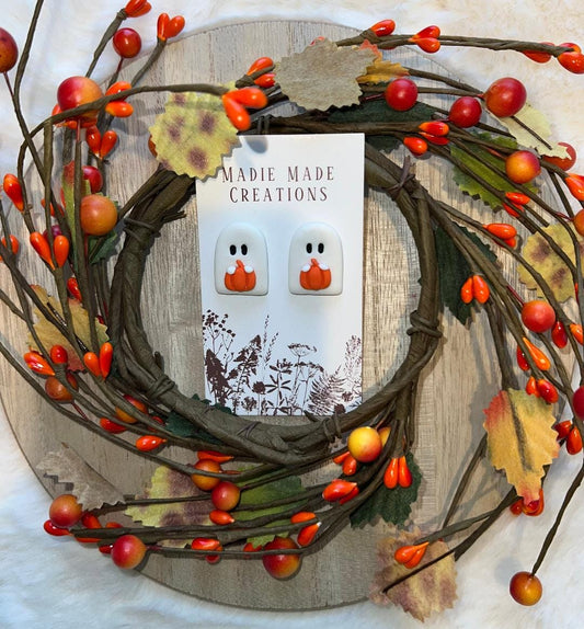 Ghost holding pumpkin studs